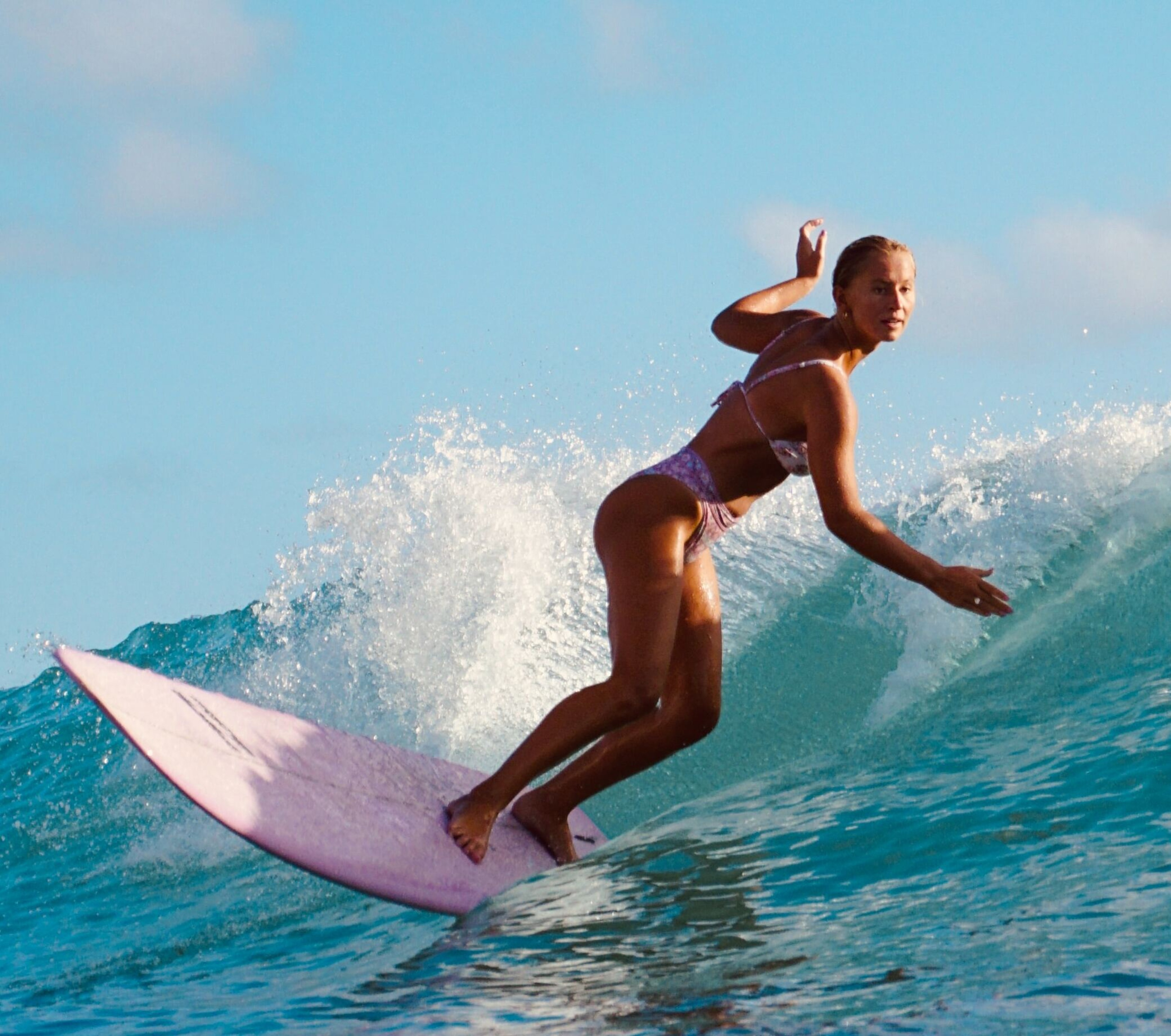 Woman surfing on green wave